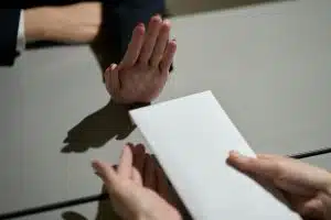 Hand of a woman who refuses to receive money