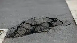 Asphalt road damaged. cracked road after earthquake. Poor asphalt surface.