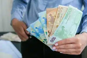 Business Woman Displaying a Spread of Cash euros. Close-up. Income and Business concept. Venality, b