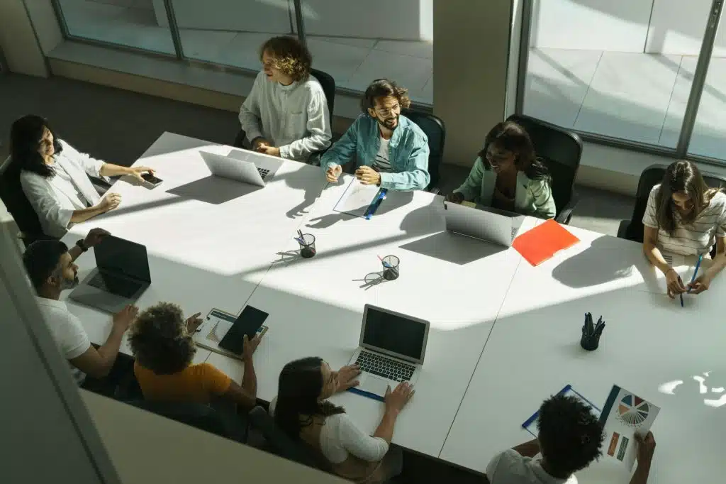 Group of young diverse professional people in smart casual wear discussing business