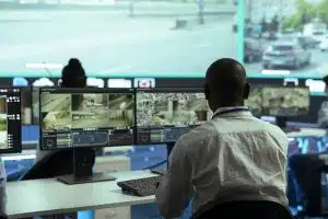 Observation room employee reviewing video surveillance footage