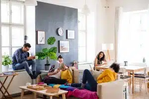 A group of young friends relaxing indoors, house sharing concept