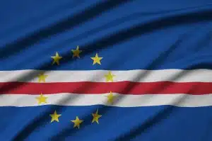 Cabo verde flag is depicted on a sports cloth fabric with many folds. Sport team waving banner