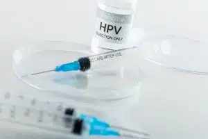 Composition of hpv vaccine vial and syringes on white background with copy space