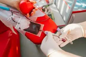 Young woman making blood donation in hospital. Blood donation.